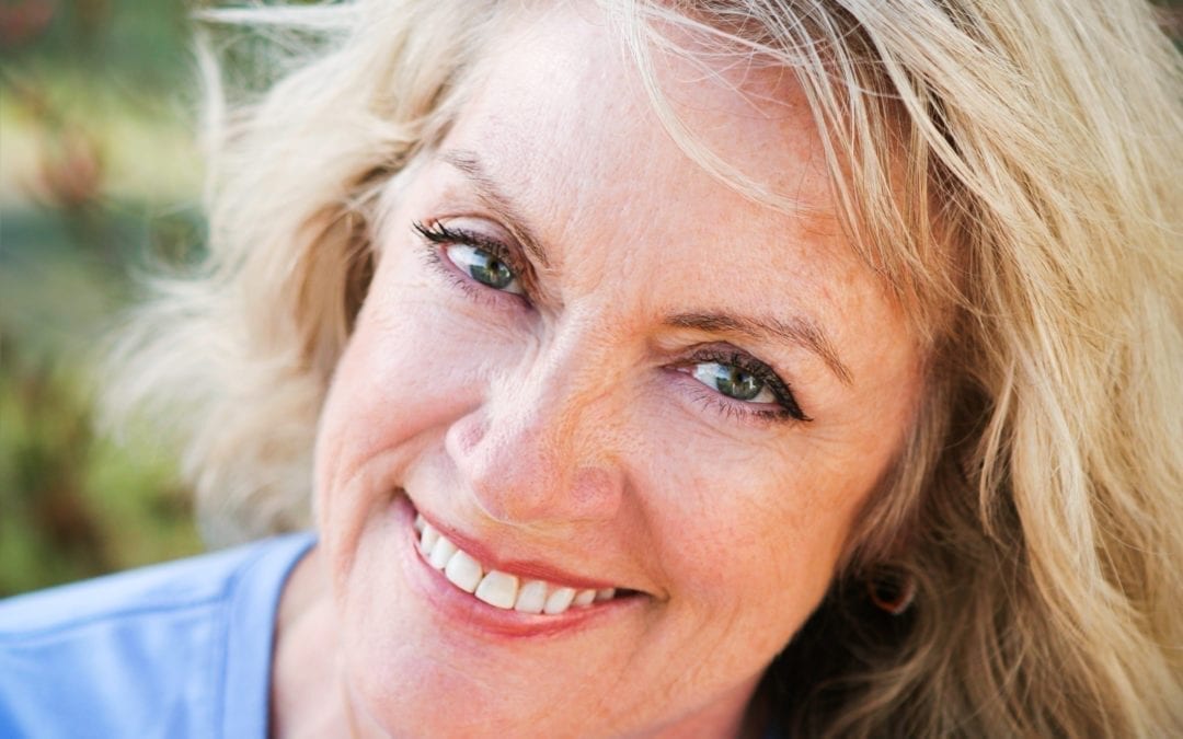 happy middle aged woman smiling into camera