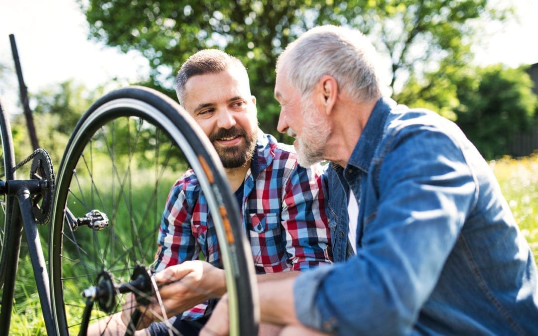 father and son fixing puncture on push bike
