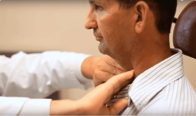 Man having his neck examined